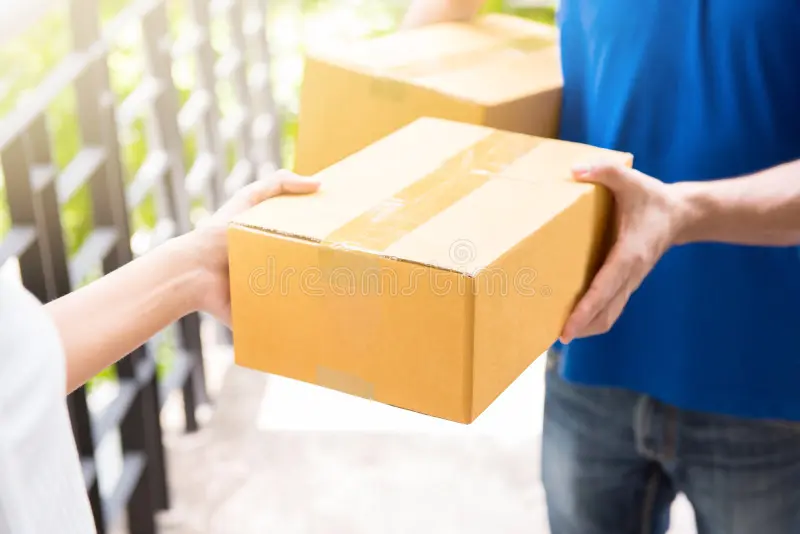 delivery man blue uniform handing parcel box to recipient courier service concept 84275323